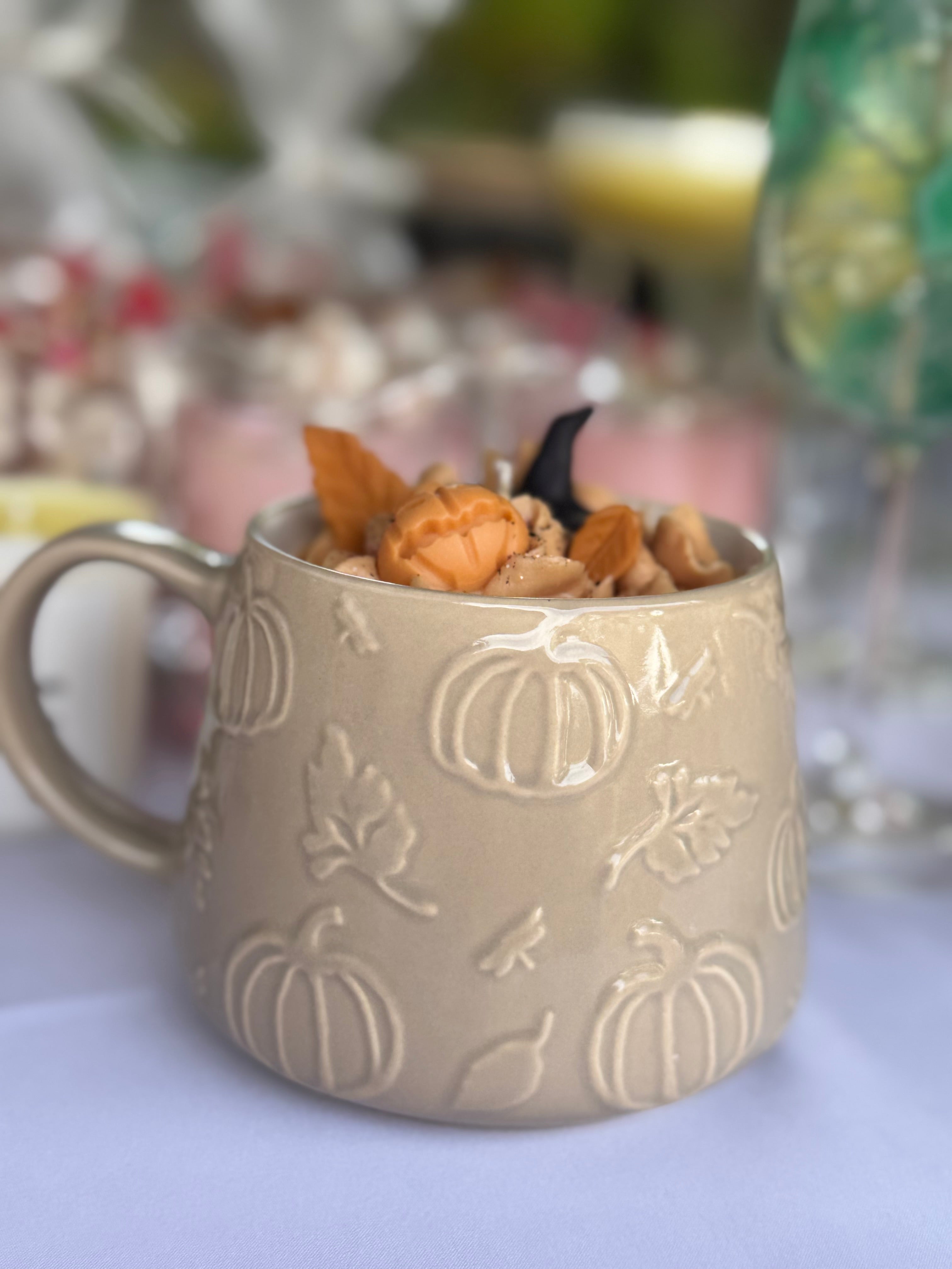 Halloween pumpkin spice soy candle close up with pumpkin and witch hat decoration
